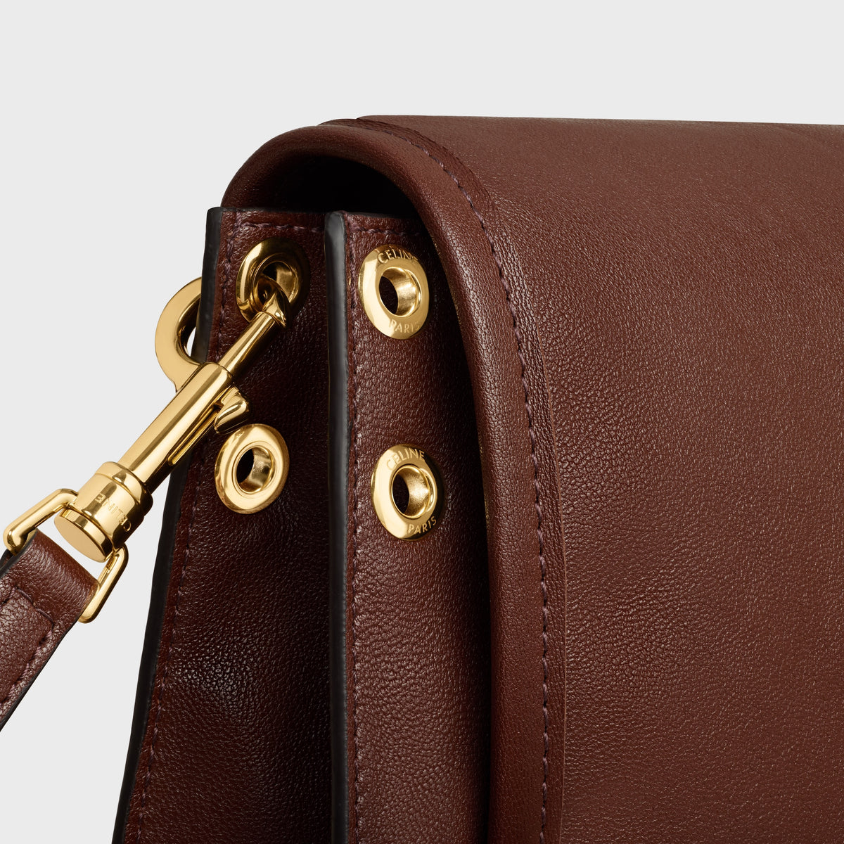 Soft Triomphe Besace in Supple Shiny Lambskin - Deep Brown - side strap and eyelet detail