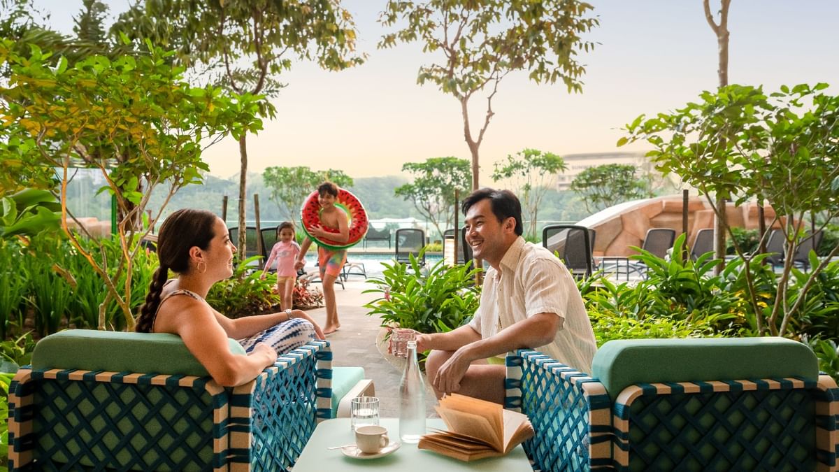 Family relaxing beside Waterventure at Sunway Resort